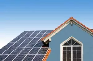 modern new built house, rooftop with solar cells, blue front wit