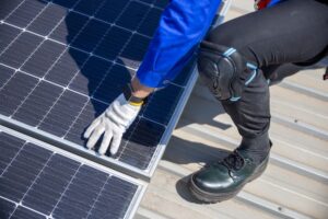 Technicians are installing and inspecting standards of solar panels on roof of an industrial factory. Electrical energy obtained from nature sunlight clean renewable energy.